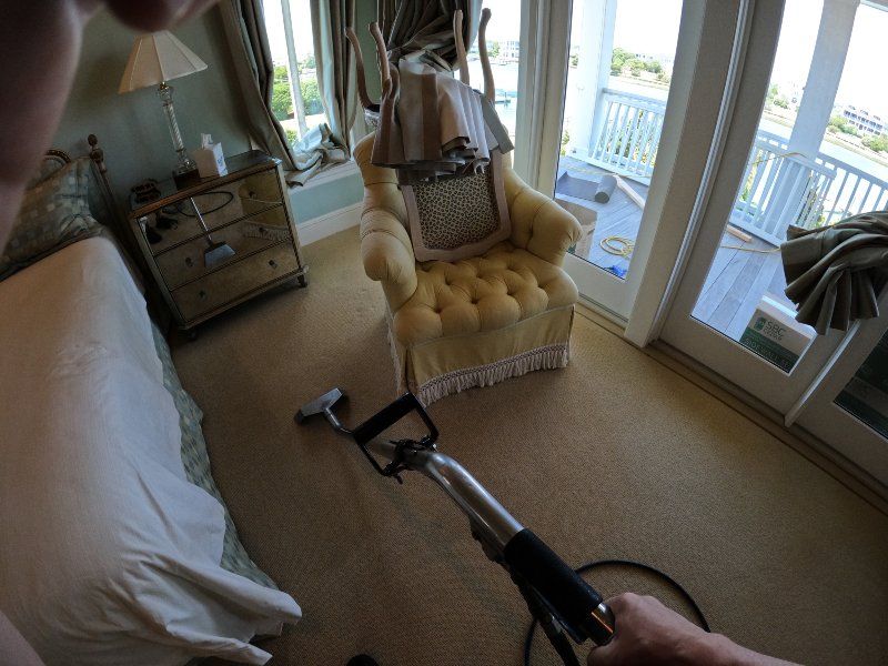 Carpet cleaning in progress in a luxury beachfront home bedroom with ocean view in Wilmington NC area