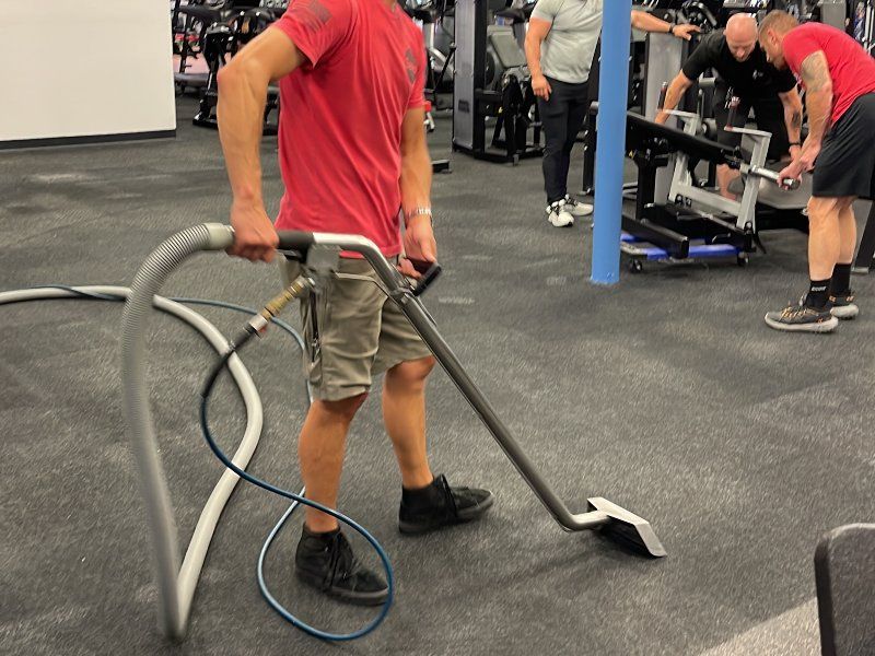 Sano Steam technician steam cleaning commercial gym carpet with extraction wand in Wilmington NC