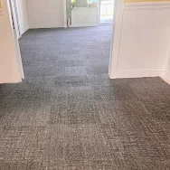 Commercial hallway carpet cleaned and restored showing even pattern — Eugenia-Divine Casey review