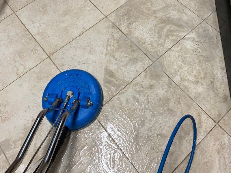 Sano Steam SX-12 tile cleaning spinner tool in action on dirty tile floor showing clean vs dirty contrast